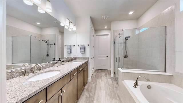 bathroom with vanity, wood-type flooring, and independent shower and bath