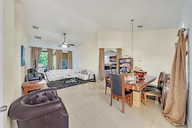 dining room with ceiling fan, light tile patterned floors, and lofted ceiling