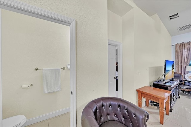 interior space featuring toilet and tile patterned floors