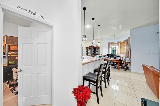 kitchen with hanging light fixtures and light tile patterned flooring