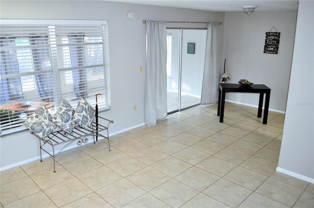 foyer entrance with light tile patterned flooring