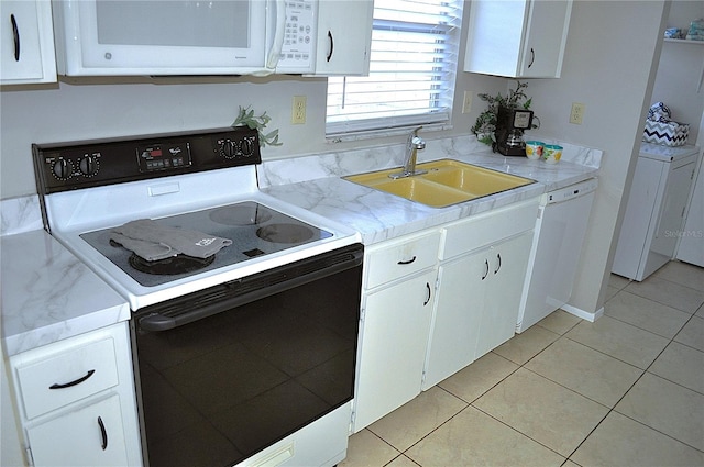 kitchen with white cabinetry, sink, white appliances, and light tile patterned flooring