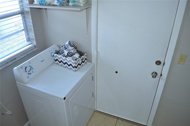 washroom with light tile patterned floors and washer and clothes dryer