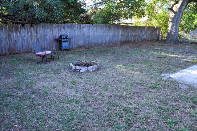 view of yard with a fire pit