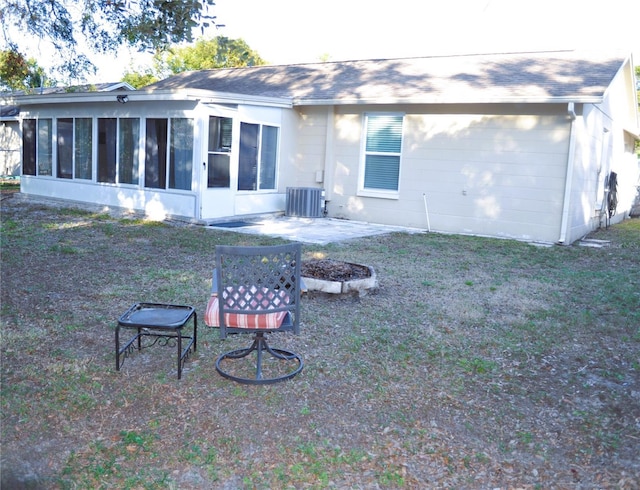 back of house featuring a yard, central AC, a sunroom, and a patio area