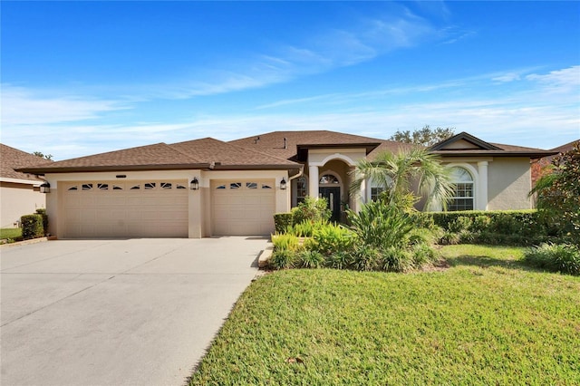 view of front of house with a garage and a front lawn