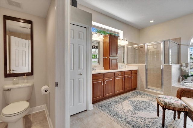 bathroom with toilet, tile patterned floors, and a shower with door