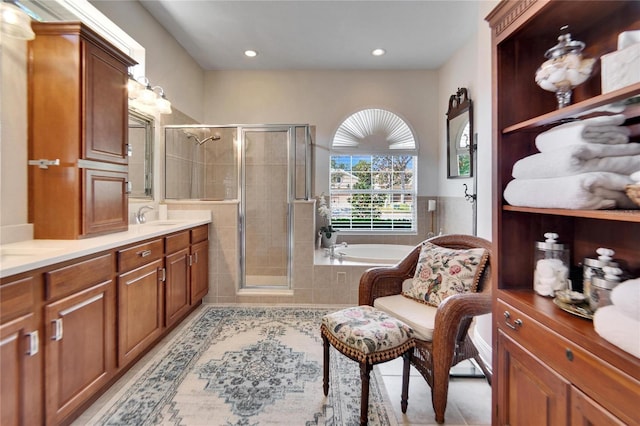 bathroom featuring separate shower and tub, tile patterned flooring, and vanity