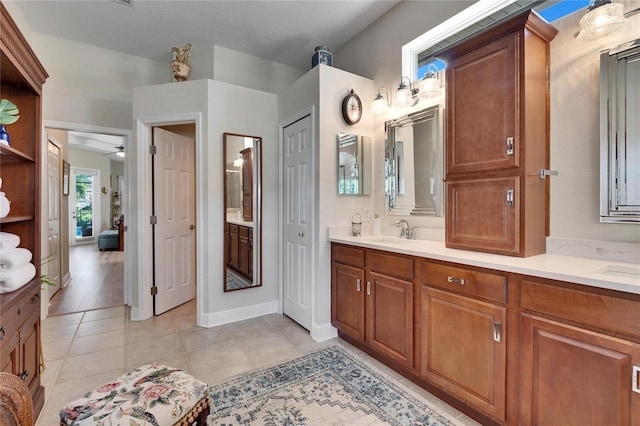 bathroom with ceiling fan, tile patterned flooring, and vanity