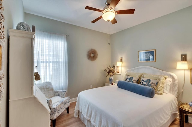 bedroom with multiple windows, ceiling fan, and light wood-type flooring