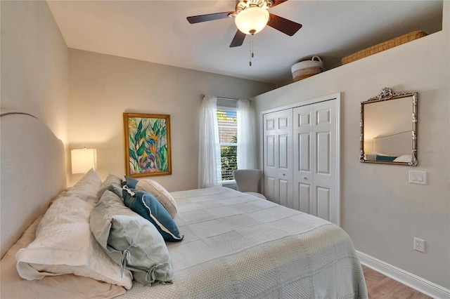 bedroom with hardwood / wood-style flooring, a closet, and ceiling fan