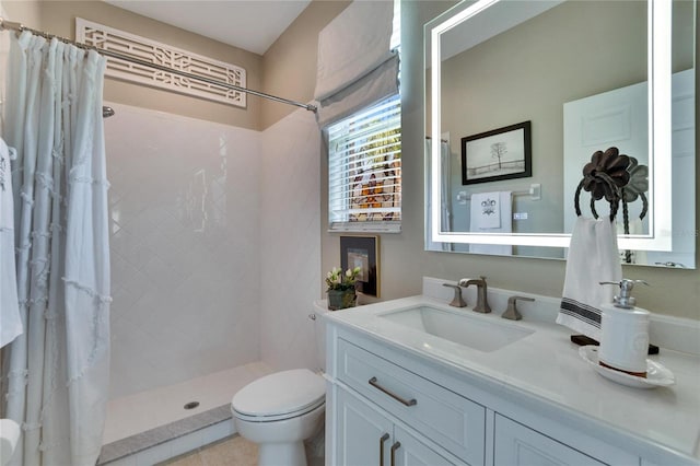 bathroom with curtained shower, vanity, and toilet