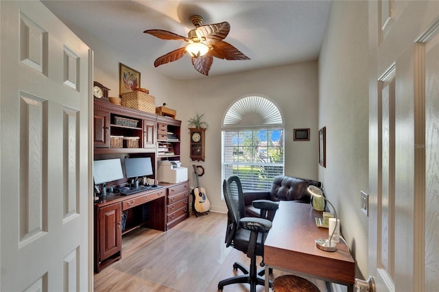 home office with ceiling fan and light hardwood / wood-style flooring