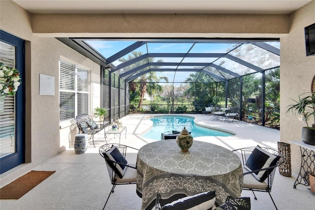 view of pool with a patio and glass enclosure