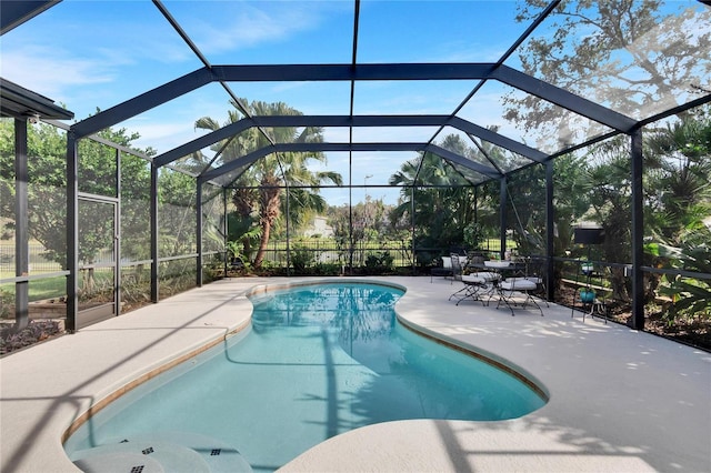 view of pool with a lanai and a patio