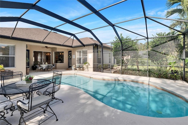 view of pool with ceiling fan, a patio area, and a lanai