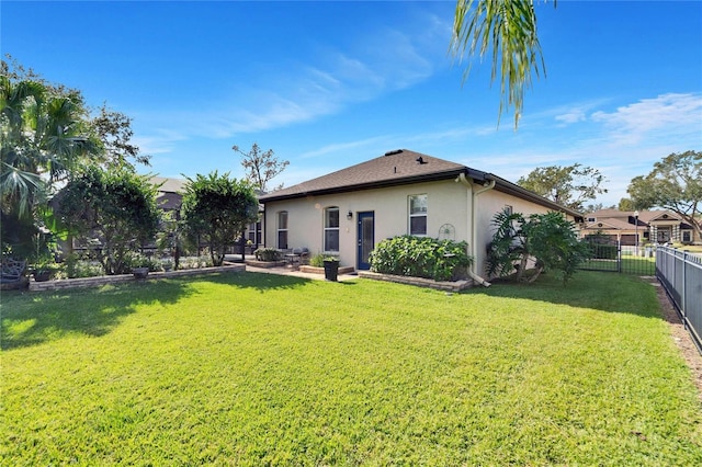 rear view of property with a lawn