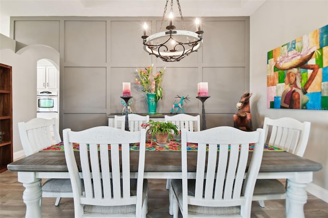 dining area featuring a notable chandelier and wood-type flooring