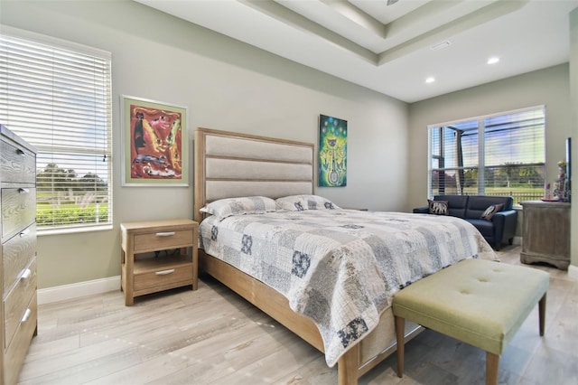 bedroom featuring light hardwood / wood-style floors and multiple windows