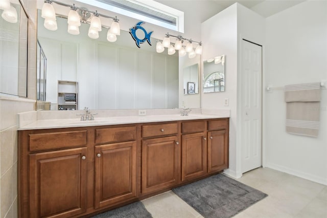 bathroom featuring vanity, a healthy amount of sunlight, and a shower with shower door