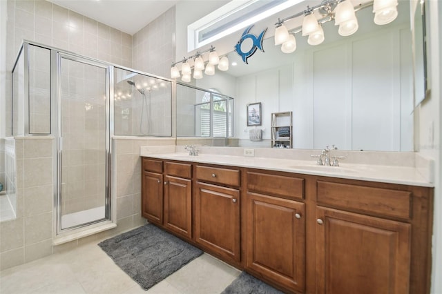 bathroom featuring tile patterned flooring, vanity, and walk in shower