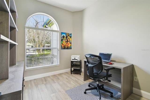 office area with plenty of natural light and light wood-type flooring