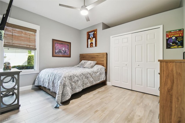 bedroom featuring ceiling fan, a closet, and light hardwood / wood-style flooring