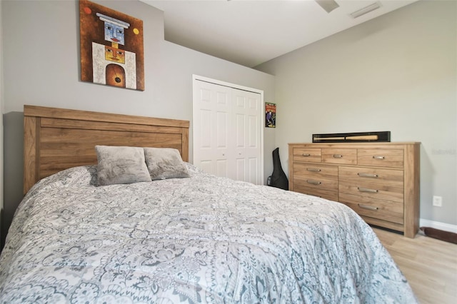 bedroom with light wood-type flooring and a closet