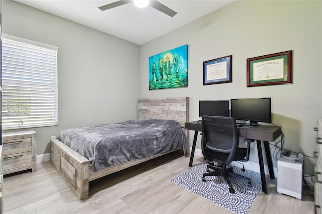 bedroom with ceiling fan and light wood-type flooring