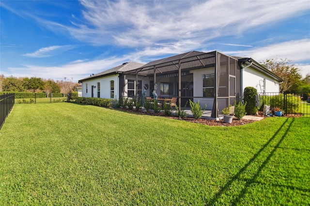 rear view of house with a lanai and a lawn