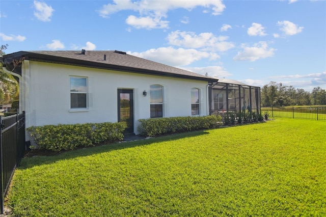 back of property featuring a yard and a lanai