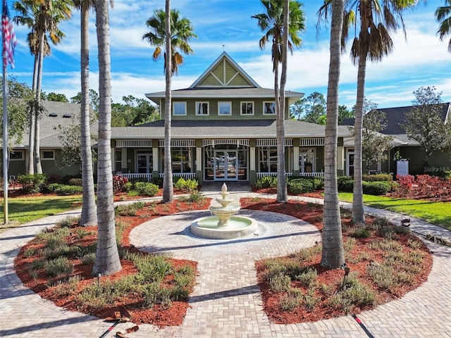 exterior space featuring a porch and french doors