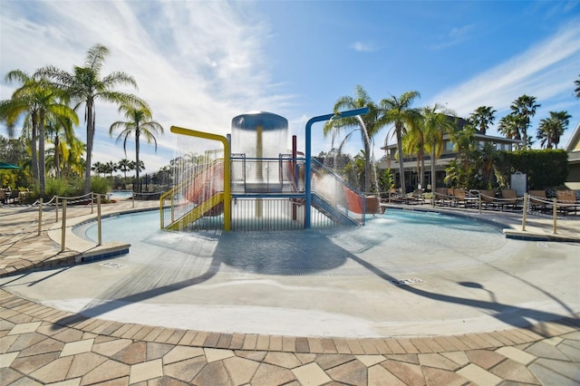 view of jungle gym with a community pool