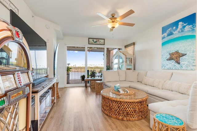 living room featuring ceiling fan and light wood-type flooring