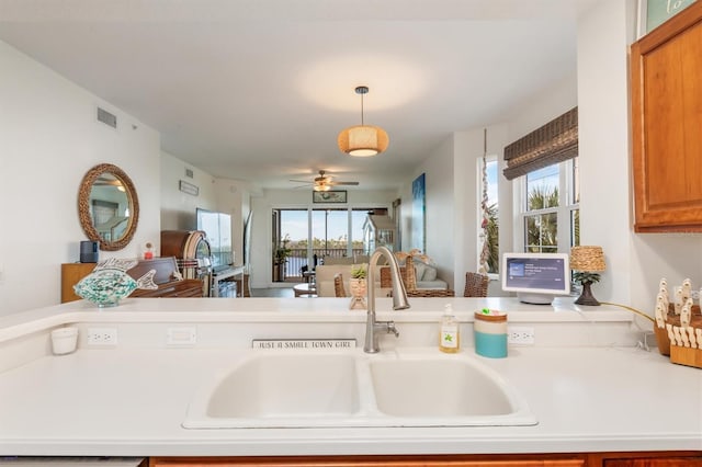 kitchen featuring pendant lighting, ceiling fan, and sink