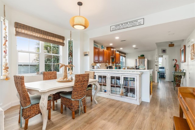 dining area with light hardwood / wood-style flooring