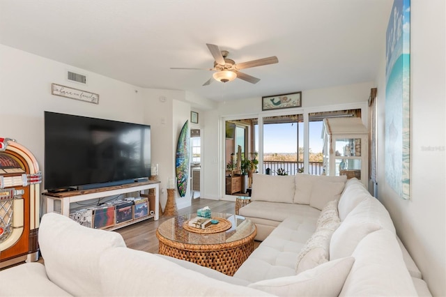 living room featuring ceiling fan and wood-type flooring