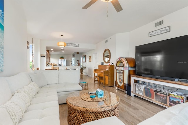 living room with ceiling fan and light hardwood / wood-style floors