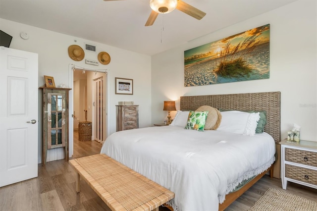 bedroom with hardwood / wood-style floors and ceiling fan