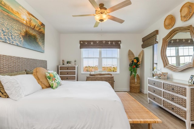 bedroom with ceiling fan and light wood-type flooring