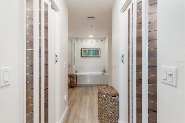 bathroom featuring hardwood / wood-style floors and a bathtub