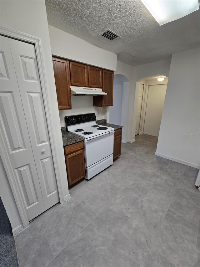 kitchen featuring white range with electric cooktop and a textured ceiling