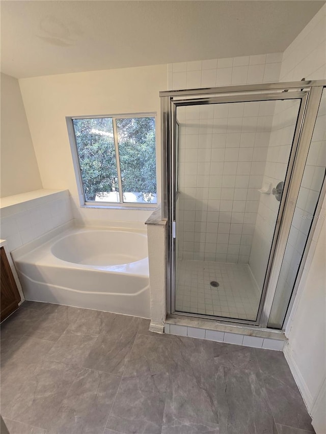 bathroom featuring tile patterned floors, vanity, and separate shower and tub