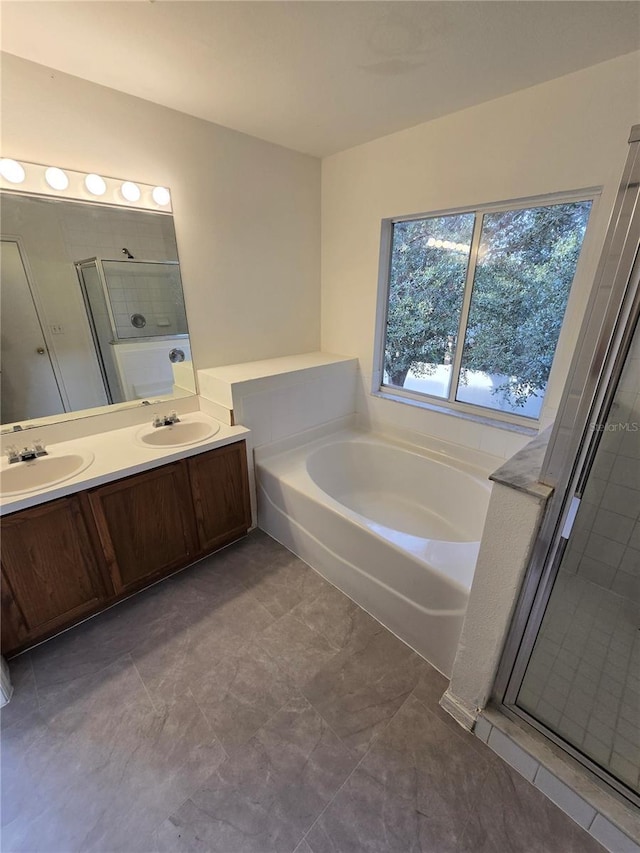 bathroom with tile patterned flooring, shower with separate bathtub, and vanity