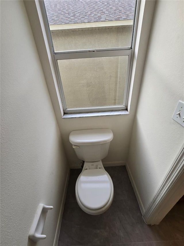 bathroom featuring a healthy amount of sunlight and toilet