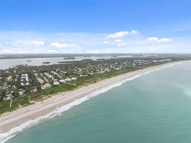 bird's eye view with a water view and a beach view