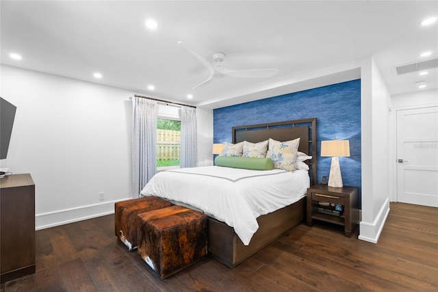 bedroom with dark hardwood / wood-style floors and ceiling fan