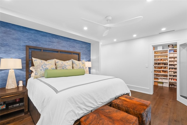 bedroom with dark hardwood / wood-style floors and ceiling fan