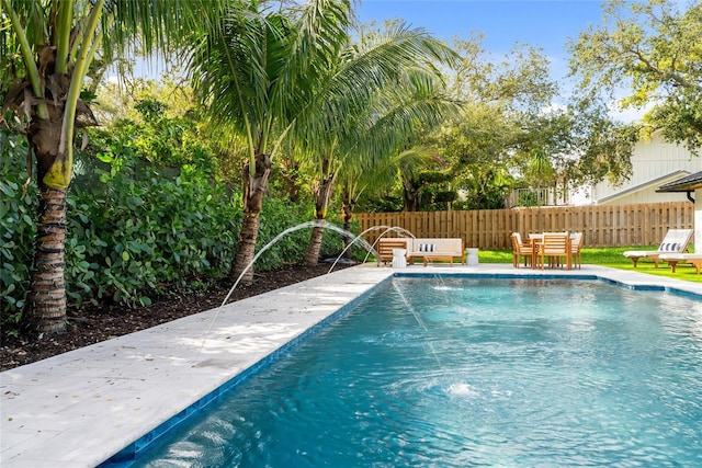 view of swimming pool with pool water feature