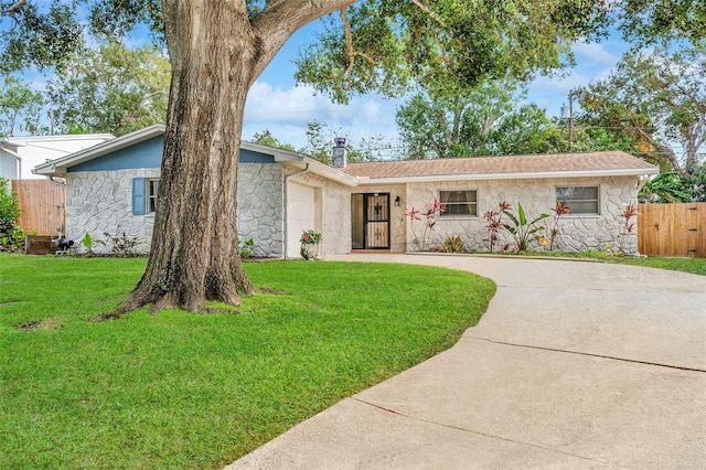 single story home with a front yard and a garage